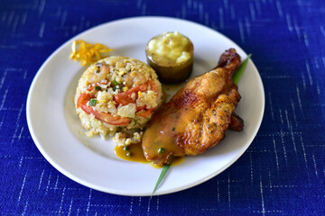 African national dish grilled chicken With fried rice and flavored water. Healthy lifestyle eating. on a white plate. selective focus