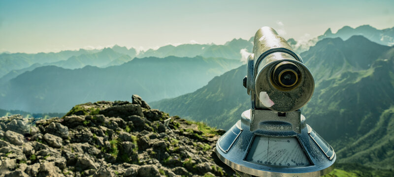 Binoculars telescope in the mountains alps in the Kleinwalsertal in Austria with a great view