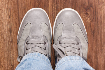 Comfortable gray leather shoes on rustic board, male footwear