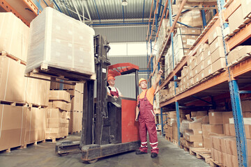Warehousing and storage. warehouse workers works with forklift loader © Kadmy