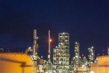 Fototapeta na wymiar Twilight scene of tank oil refinery plant and tower column of Petrochemistry industry