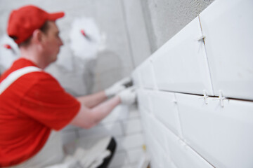 Tiler installing tile on bathroom wall. home indoors renovation