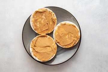 Peanut butter and rice cakes sandwich. Healthy protein snack.