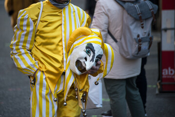 Basel - Switzerland - 9 March 2022 - portrait of masked people wearing traditional costume walking...