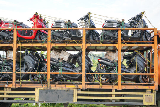 Pati, Indonesia - March, 2022 : Automatic motorcycle transport truck with several floors that can accommodate large quantities to be sent to the showroom.