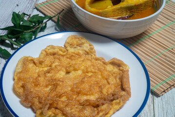 Omelette in a white plate. Easy-to-make meals are high in protein.
