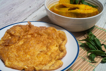 Omelette in a white plate. Easy-to-make meals are high in protein.