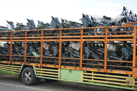 Pati, Indonesia - March, 2022 : Automatic motorcycle transport truck with several floors that can accommodate large quantities to be sent to the showroom.