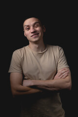 Obraz premium Handsome guy posing in studio on isolated black background. Studio portrait with one light source.