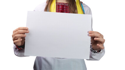 Little cute Ukrainian girl 11 years old posing in the studio on a white background. The child holds a blank white sheet in his hands. Preparation for the inscription.