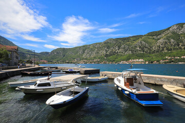 Fototapeta na wymiar Boats in the harbor in the city of Kotor