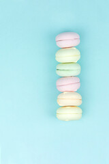 Fototapeta na wymiar Multi Colored Stacked Up French marshmallow looks like Macarons on Blue, concept of sweet dessert.