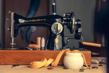 An old retro sewing machine with a place and items for a dressmaker.