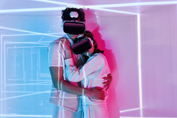 Couple embraced in VR headset in bright studio