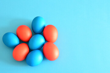 red and blue easter eggs on blue background, close-up