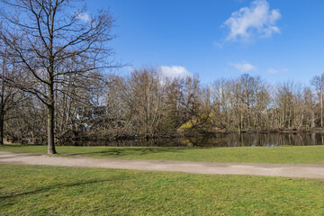 Fototapeta na wymiar Views of the wonderful Vondelpark - public urban park of 47 hectares in Amsterdam in early spring. Vondelpark was opened in 1865. Amsterdam, the Netherlands.