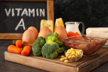 Set of healthy products rich in vitamin A on dark background