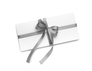 Card with silver ribbons and bow on white background