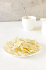 Healthy organic dessert: dried (dehydrated) Aloe Vera chunks on table, concrete background, vertical plane. Healthy snack.