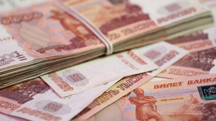 Banknotes of Russian 5000 rubles. A stack of five-thousandth banknotes tied with a rubber band