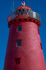 red lighthouse on the pier in dublin, ireland