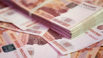 A stack of five-thousandth banknotes tied with a rubber band. Banknotes of Russian 5000 rubles.