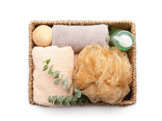 Basket with bath accessories on white background
