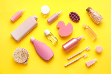 Composition with different cosmetic products and bath supplies on yellow background