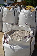 Bags of gravel and sand. Construction materials. Large bags of aggregates for concrete mixes.