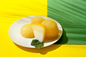 Fototapeta na wymiar Plate with tasty melon sorbet on color background