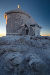 Winter view of the Meteorological Observatory on Śnieżka in the Karkonosze Mountains. The...