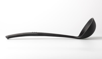 Black kitchen ladle for soup on a white background. Concept of kitchen utensils or tool