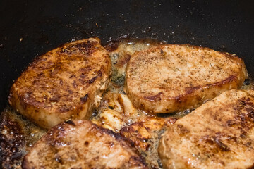 cooking pork steaks in a pan. Cooking. Close-up