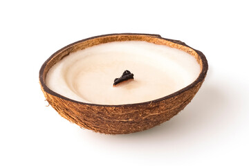 Decorative candle in a coconut on a white background. Interior decor. Close-up
