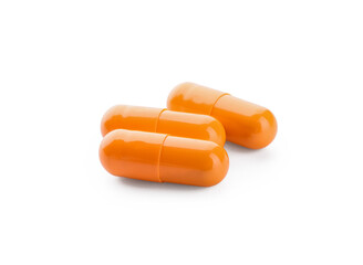 Turmeric powder capsules on white background