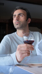 Man drinks wine in minimal luxury restaurant in hotel for summer time. 