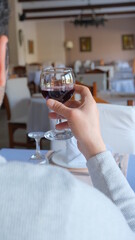 Man drinks wine in minimal luxury restaurant in hotel for summer time. 