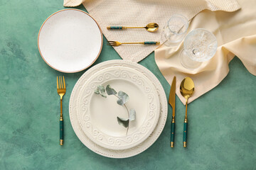Elegant table setting on green background