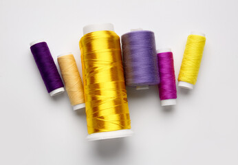 Different thread spools on white background