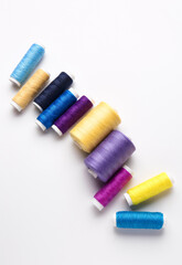 Different thread spools on white background