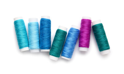 Different thread spools on white background