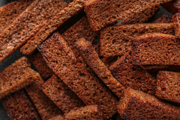 Tasty rye croutons as background, closeup