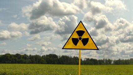 Radiation sign on a against the sky and greenery. 3D render - obrazy, fototapety, plakaty