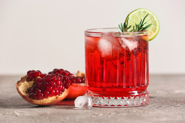 Glass of tasty pomegranate cocktail on table