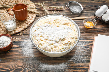 Bowl of dough for Italian Easter bread on wooden background