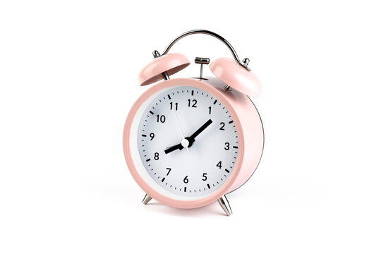 Pink vintage alarm clock on white isolated background.