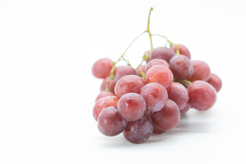 Bunch of red grapes with water drops. Isolated on white background.