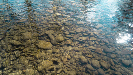 The stones lie in a shallow river with a good current