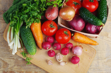 Fresh vegetables on a wooden texture table.