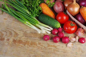 Fresh vegetables on a wooden texture table.